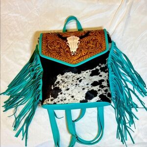 Western tooled turquoise backpack with fringe.